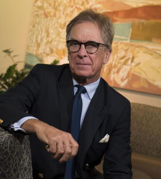 Photo of man in suit against neutral background