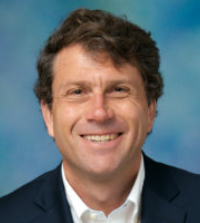 portrait of man with brown hair on blue background