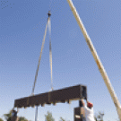 A crane lowers the Morris Fountain&acirc;&#128;&#153;s crossbeam into place as workers prepare to bolt it to the concrete pillars on July 27. Water will shoot up pipes in the columns, then fall in a sheet&acirc;&#128;&#148;like a theatre curtain&acirc;&#128;&#148;from the crossbeam. 