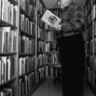 Above, Michael Harrison, reads one of his 21,000 books in 1984. Harrison, who passed away in April 2005 at the age of 107, donated his Western book collection to campus. On the front, Michael Westergard&rsquo;s bronzes of the history, wildlife and p