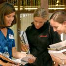 Student advising co-director Tammy Hoyer talks with newly-admitted incoming students Kerry Klotzbach and Anna Bokides.