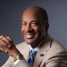 Chancellor Gary S. May, portrait, smiling, hands clasped