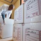 Chancellor Gary S. May unpacks a box in his office.