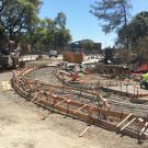 Road grading and sidewalk construction at bridge project