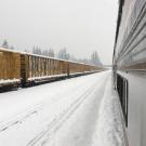 View of freight cars, from Amtrak train stranded in the snow