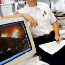 Wes Arvin pulls an image taken at the &ldquo;Old Fire,&rdquo; the name given to the recent San Bernardino Hills blaze, onto his computer. Arvin&rsquo;s team saved about 13 houses and, &ldquo;most importantly,&rdquo; he says, &ldquo;all returned home safely.&rdquo;