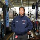 Alumna Kimmy Nguyen in a bus yard