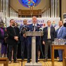 Community leaders address the media in a church