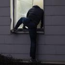 Thief climbing in window