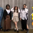 Six diverse Aggies standing side by side wearing items from the Arneson Egghead Collection