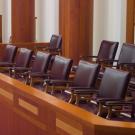 Scene in courtroom with chairs in jury box