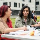 Students conversing at table on university campus