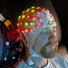 Individual with EEG equipment on head 