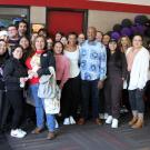 Group photo of students and Chancellor Gary S. May in movie theater lobby.