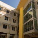 Exterior photo of a 4-story residence hall entrance courtyard