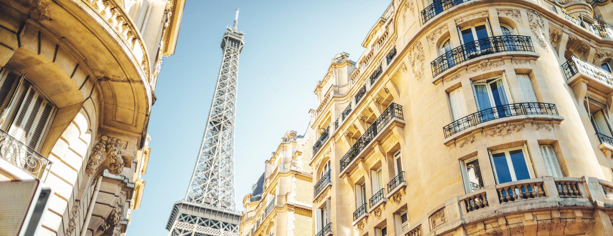 A view of the Eiffel Tower from a Parisian street