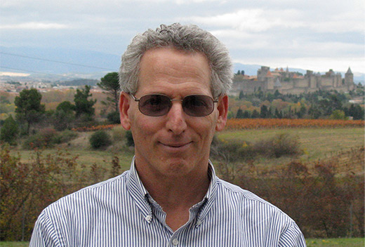 Portrait of Alan Bakalinksy with older village in background