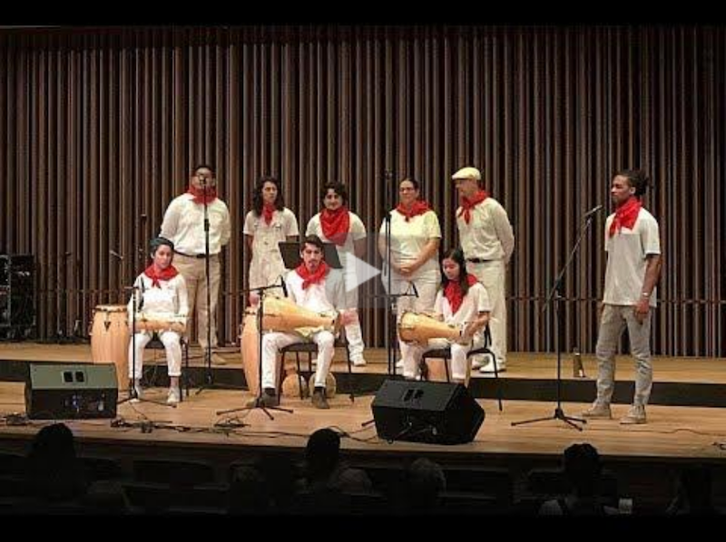 Members of the Afro-Cuban, Capoeira and Samba Ensembles performing on stage.