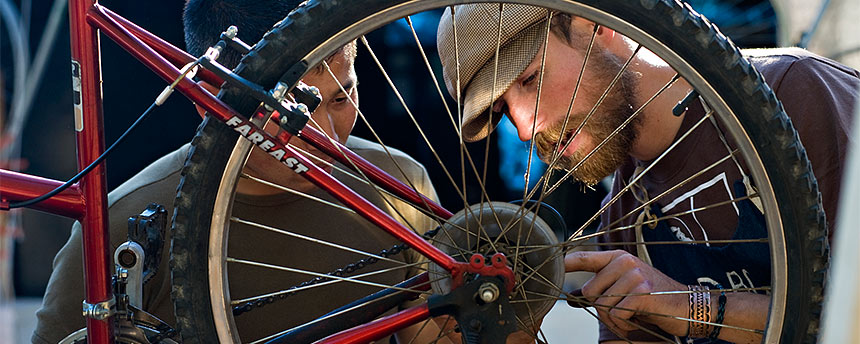 Two men fixing a bike