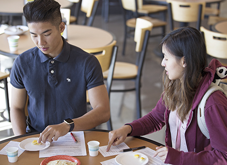 Two people eating eggs