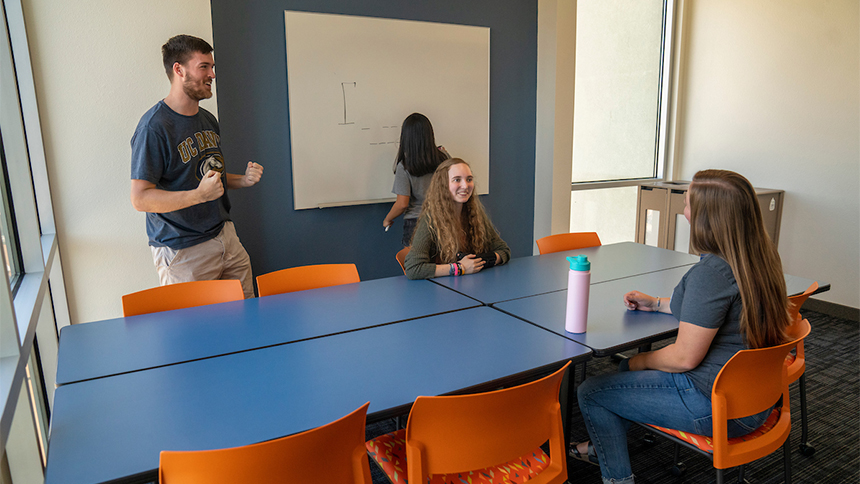 Four students at study tables