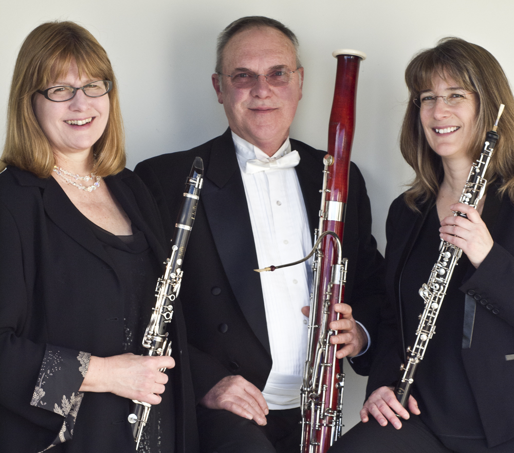 The members of the trio posing with their instruments.